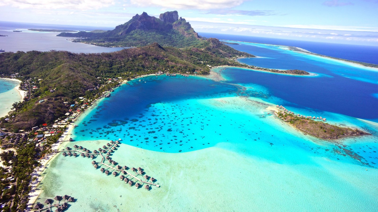 Aerial view of Bora Bora with turquoise lagoon and overwater bungalows